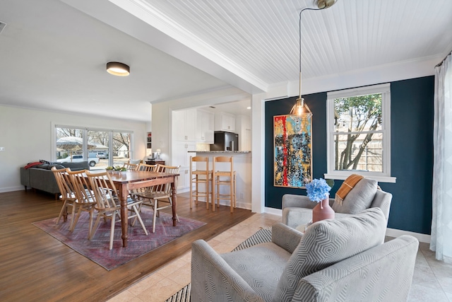 dining room featuring a wealth of natural light and light hardwood / wood-style floors