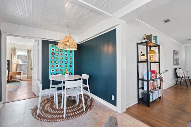 dining area with hardwood / wood-style flooring and ornamental molding