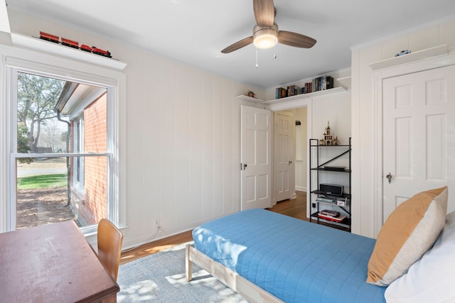 bedroom with hardwood / wood-style flooring and ceiling fan