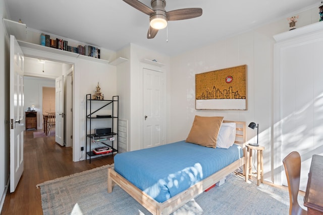 bedroom with dark wood-type flooring and ceiling fan