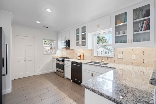 kitchen featuring white cabinetry, light stone countertops, stainless steel appliances, and sink