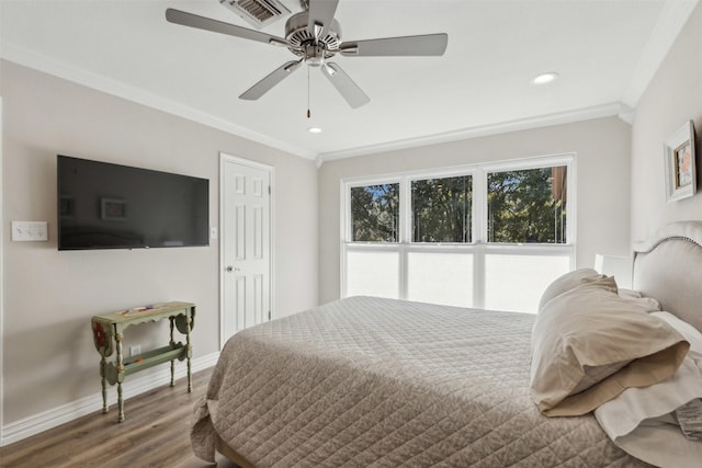 bedroom with ornamental molding, hardwood / wood-style floors, and ceiling fan