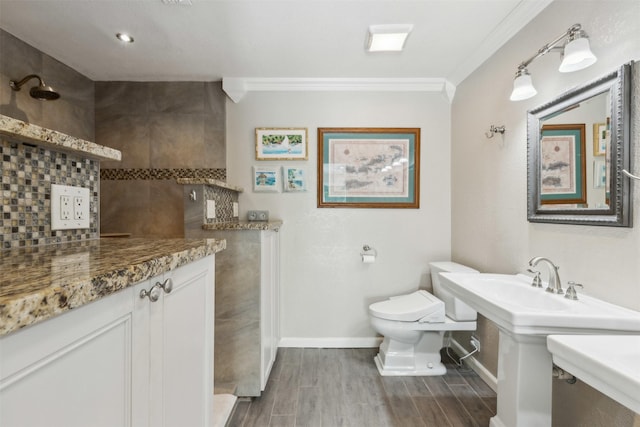 bathroom featuring hardwood / wood-style flooring, crown molding, and toilet