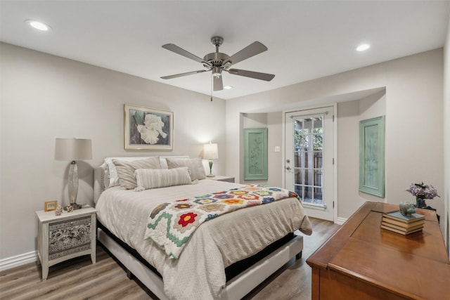 bedroom featuring hardwood / wood-style floors, access to exterior, and ceiling fan