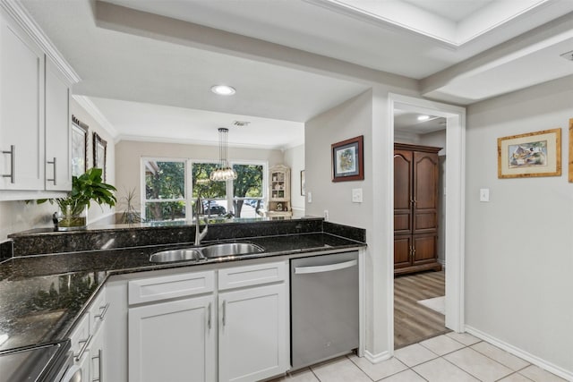 kitchen with pendant lighting, sink, stainless steel appliances, white cabinets, and dark stone counters