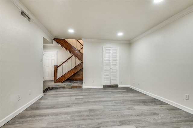 interior space with ornamental molding and hardwood / wood-style floors