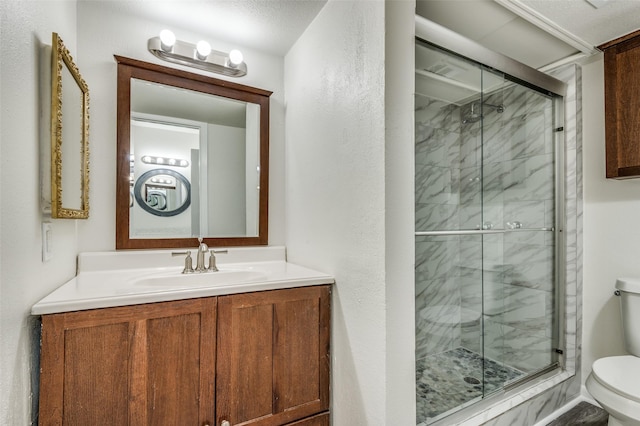 bathroom featuring vanity, toilet, and walk in shower