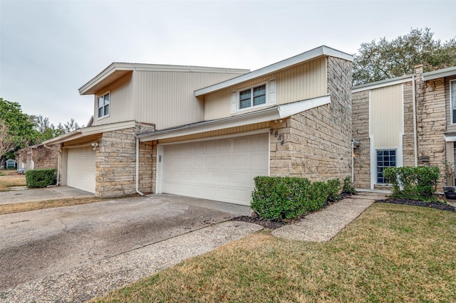 view of front of property with a garage and a front lawn