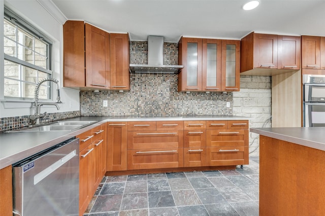 kitchen featuring sink, crown molding, stainless steel appliances, decorative backsplash, and wall chimney range hood