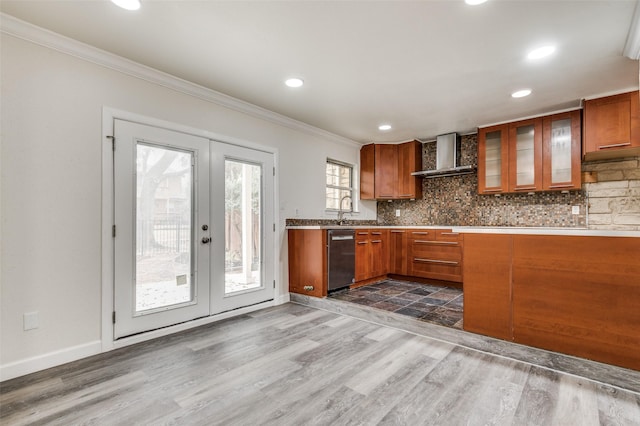 kitchen featuring ornamental molding, decorative backsplash, stainless steel dishwasher, french doors, and wall chimney exhaust hood