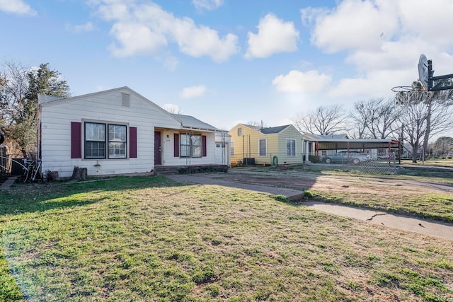 single story home featuring a front lawn and a carport