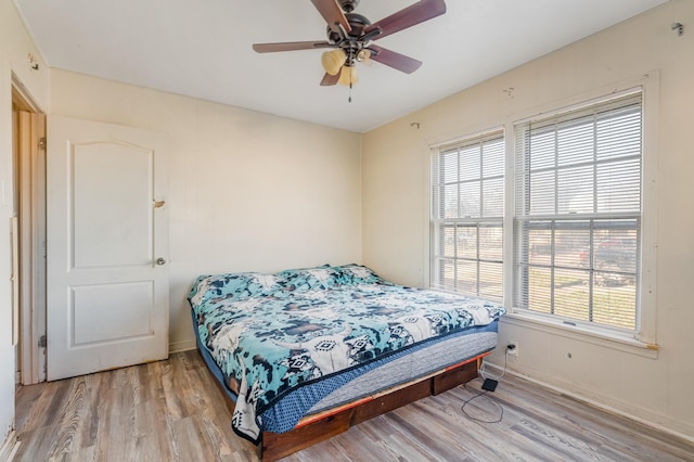 bedroom with light wood-type flooring and a ceiling fan