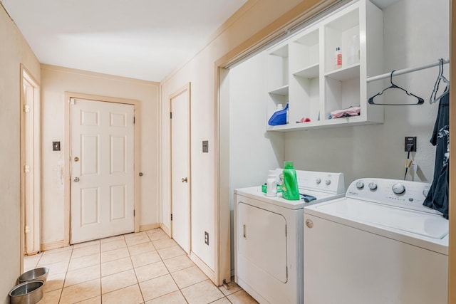 washroom with independent washer and dryer and light tile patterned floors