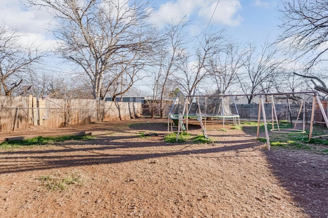 view of yard featuring a fenced backyard and a trampoline