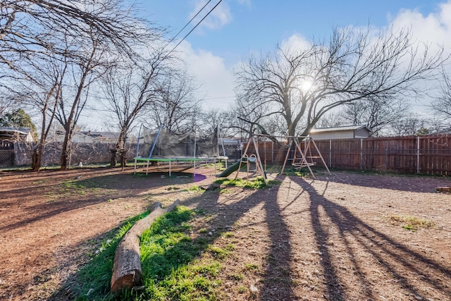 view of yard with a playground and a trampoline