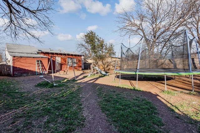 view of yard featuring a trampoline and a playground