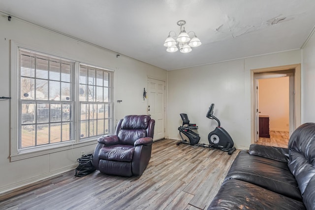 living room with a notable chandelier and light wood-type flooring