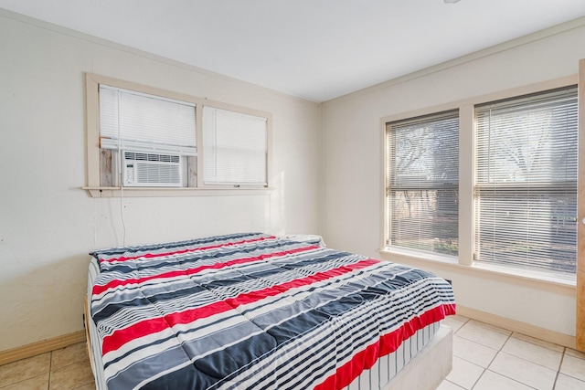 bedroom featuring light tile patterned floors and baseboards