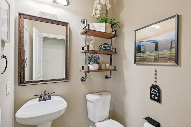 bathroom featuring sink and toilet