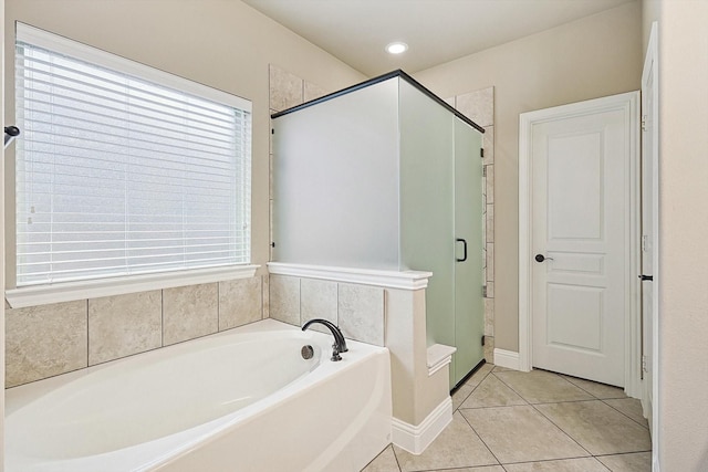 bathroom featuring shower with separate bathtub, a healthy amount of sunlight, and tile patterned floors