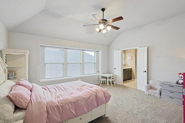 carpeted bedroom featuring connected bathroom, vaulted ceiling, and ceiling fan