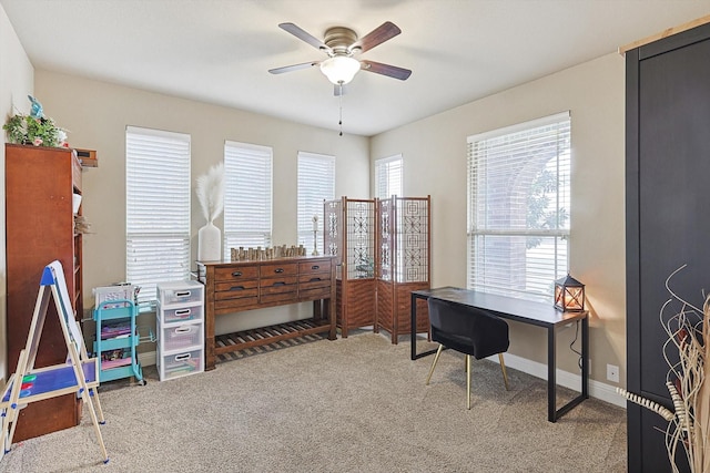 carpeted office space featuring a wealth of natural light and ceiling fan