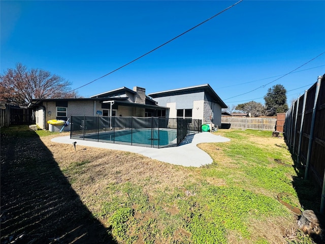 view of yard featuring a fenced in pool and a patio area