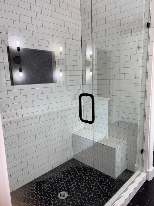 bathroom with a shower with shower door