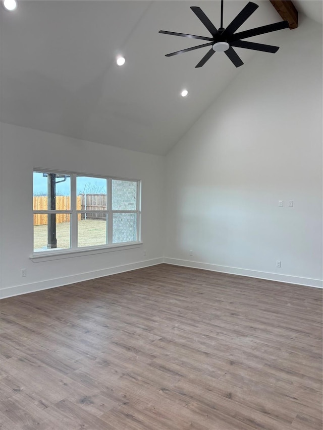 empty room featuring beamed ceiling, ceiling fan, high vaulted ceiling, and light wood-type flooring