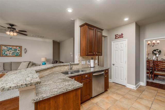 kitchen featuring visible vents, stainless steel dishwasher, open floor plan, a sink, and a peninsula