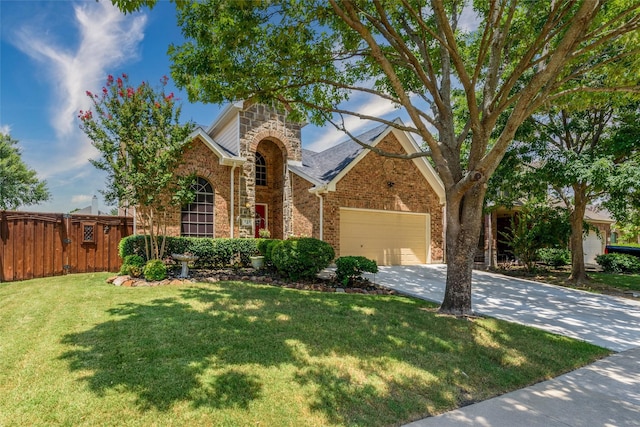 view of front of property featuring a garage and a front lawn