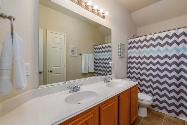 bathroom with lofted ceiling, vanity, toilet, tile patterned floors, and a shower with shower curtain