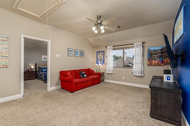 living area featuring attic access, baseboards, vaulted ceiling, and carpet flooring