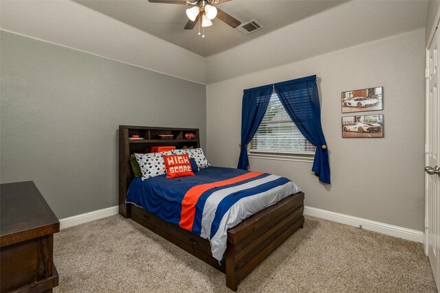 bedroom featuring ceiling fan, a raised ceiling, and carpet floors