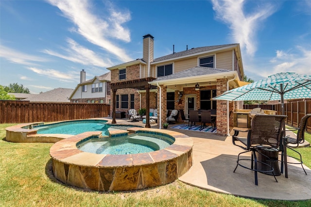 view of pool featuring outdoor dry bar, a yard, a fenced backyard, an in ground hot tub, and a patio