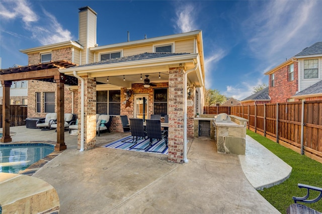 view of patio with ceiling fan, a fenced in pool, and area for grilling