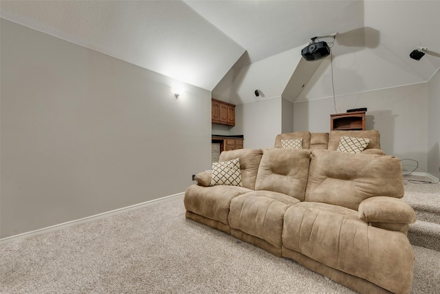 carpeted home theater room featuring lofted ceiling