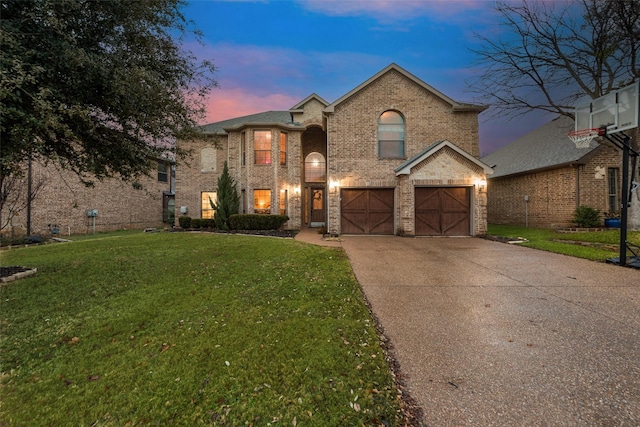 view of front of home featuring a garage and a lawn