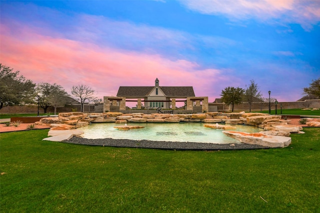 back house at dusk with a yard