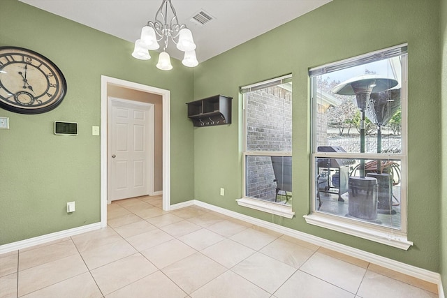 unfurnished dining area featuring light tile patterned flooring and a notable chandelier