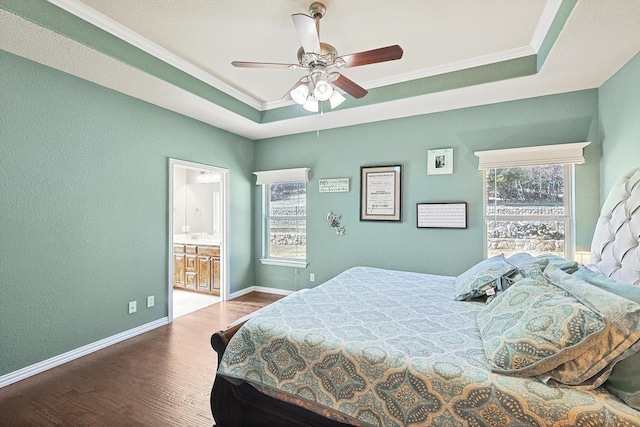 bedroom featuring a tray ceiling, wood-type flooring, ornamental molding, and ceiling fan