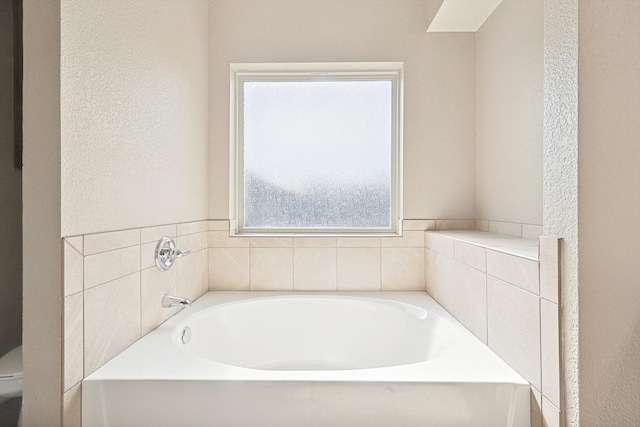 bathroom featuring a bathtub and toilet