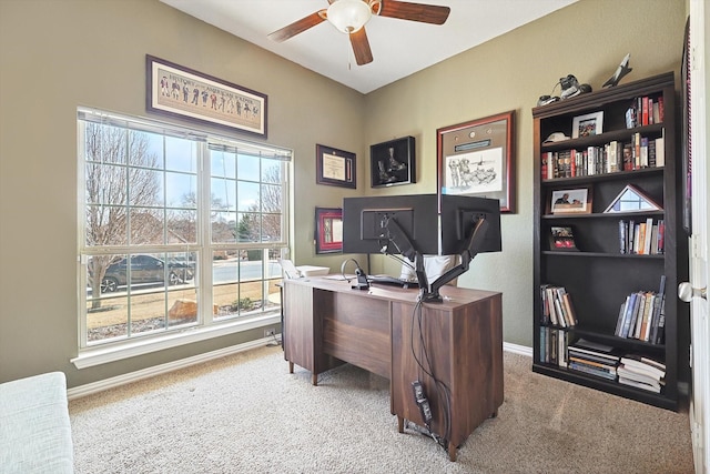 office featuring ceiling fan, baseboards, and light colored carpet