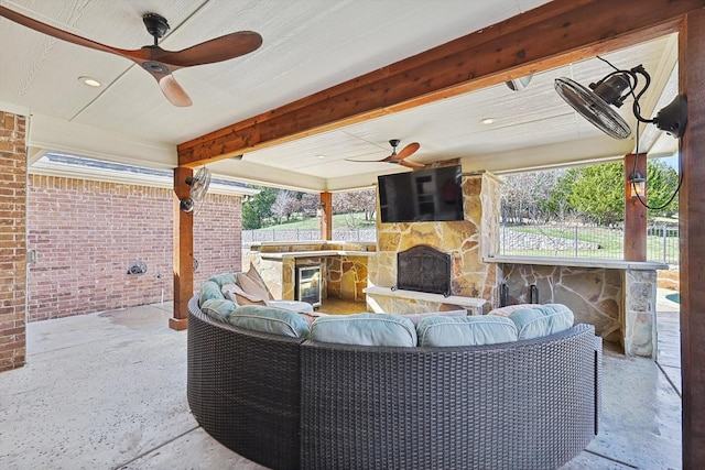 view of patio / terrace with a bar, ceiling fan, beverage cooler, and outdoor lounge area