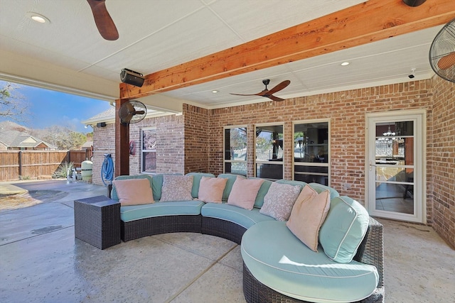 view of patio / terrace with ceiling fan, an outdoor living space, and fence