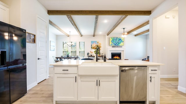 kitchen with white cabinets, black fridge with ice dispenser, dishwasher, and a center island with sink