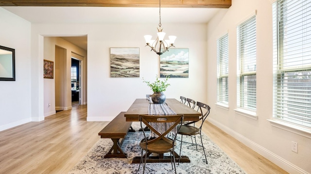 dining area with beamed ceiling, an inviting chandelier, and light hardwood / wood-style flooring