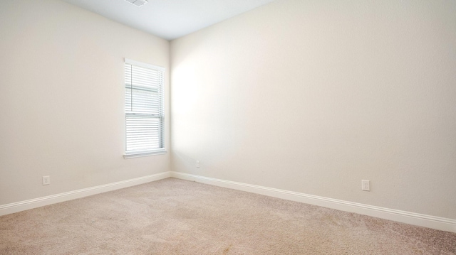 carpeted spare room with a wealth of natural light