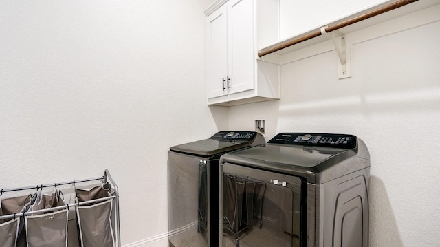 laundry area featuring cabinets and separate washer and dryer