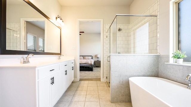 bathroom featuring tile patterned floors, shower with separate bathtub, vanity, and plenty of natural light